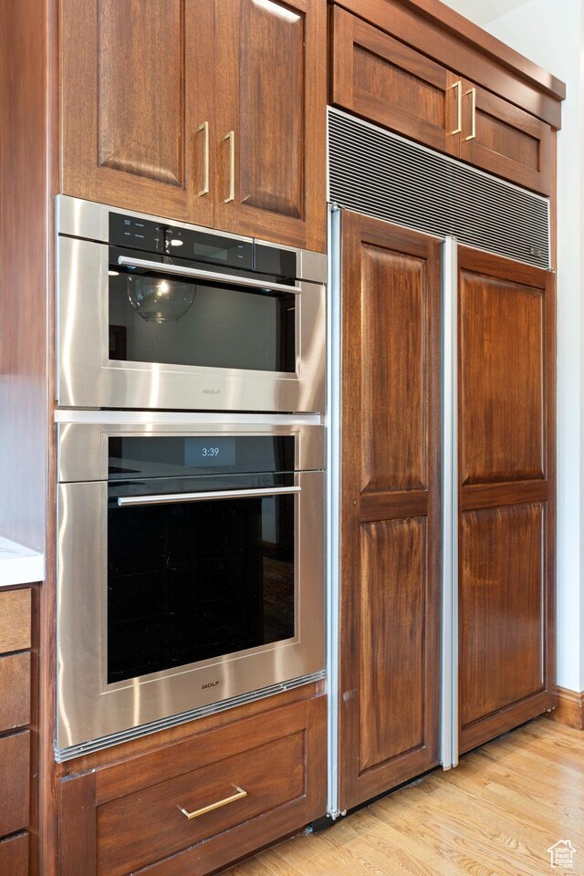 2712 S Rio Vista Dr, St George, UT 84790 - kitchen with paneled built in fridge, stainless steel double oven, and light wood-type flooring