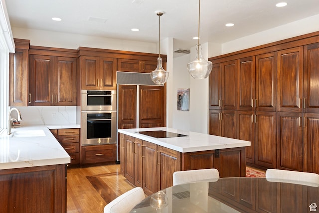 2712 S Rio Vista Dr, St George, UT 84790 - kitchen with sink, stainless steel double oven, pendant lighting, black electric stovetop, and a kitchen island