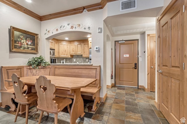 dining room featuring ornamental molding