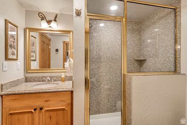 bathroom featuring vanity and an enclosed shower