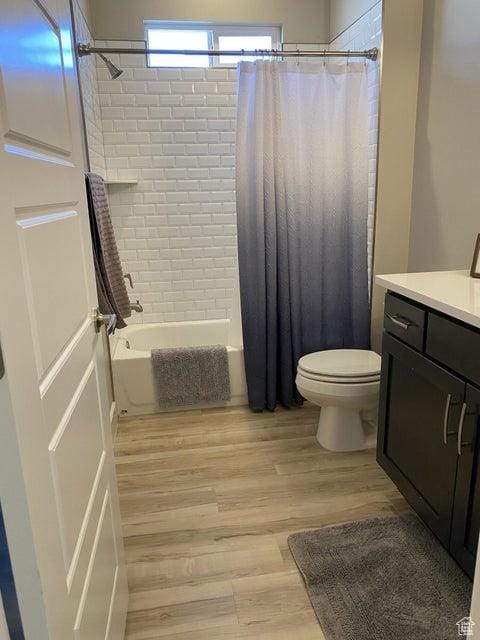 full bathroom with shower / bathtub combination with curtain, vanity, toilet, and wood-type flooring