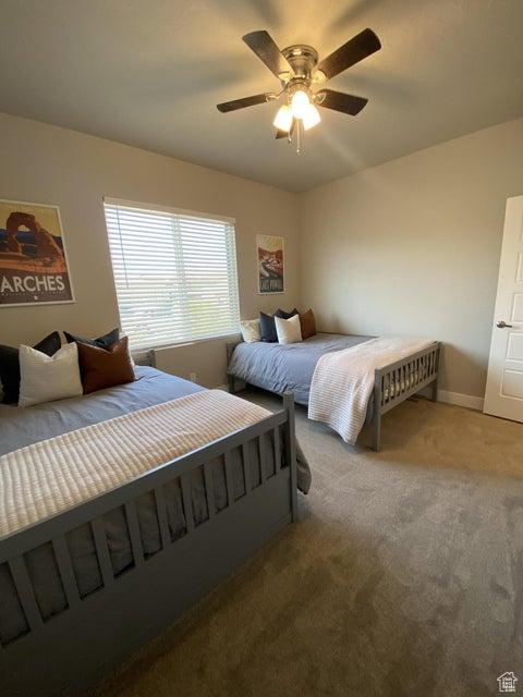 carpeted bedroom with ceiling fan