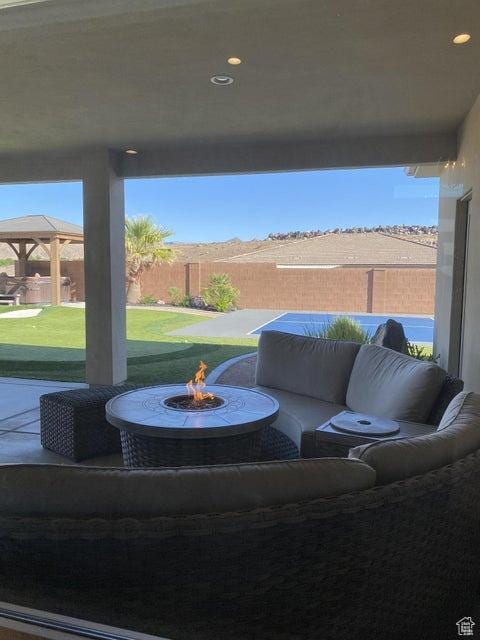 view of patio with a gazebo and an outdoor fire pit