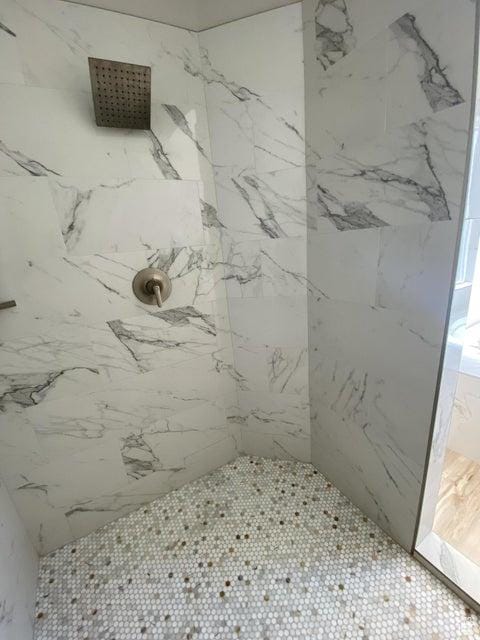 bathroom with a tile shower