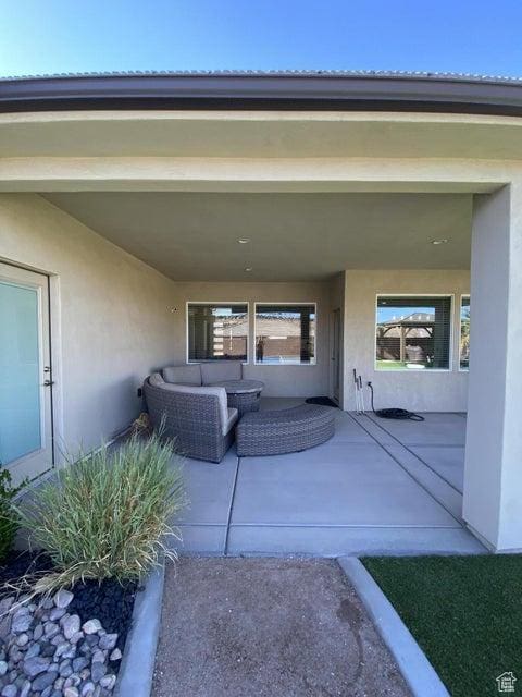 property entrance with outdoor lounge area and a patio