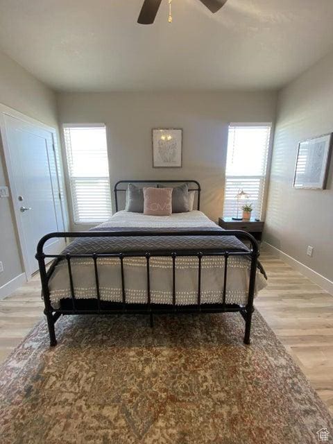 bedroom with hardwood / wood-style floors and ceiling fan