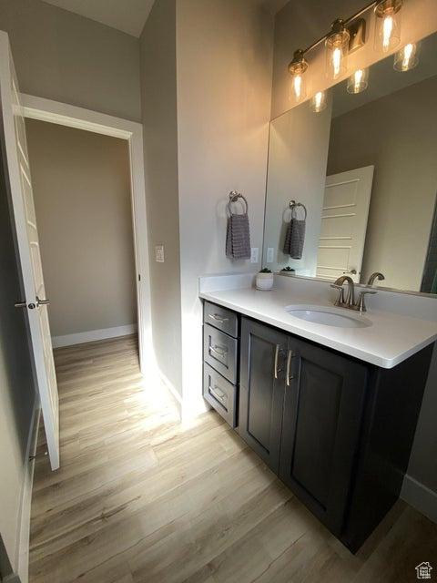 bathroom with hardwood / wood-style floors and vanity