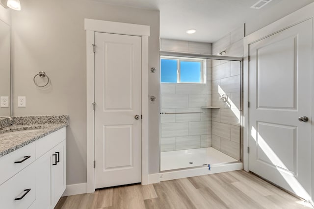 7949 N Bristlecone Rd Unit 206, Eagle Mountain, UT 84005 - full bathroom with a shower stall, visible vents, vanity, and wood finished floors