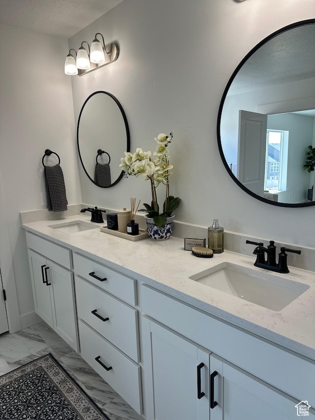 7949 N Bristlecone Rd Unit 206, Eagle Mountain, UT 84005 - full bathroom featuring marble finish floor, a sink, a textured ceiling, and double vanity