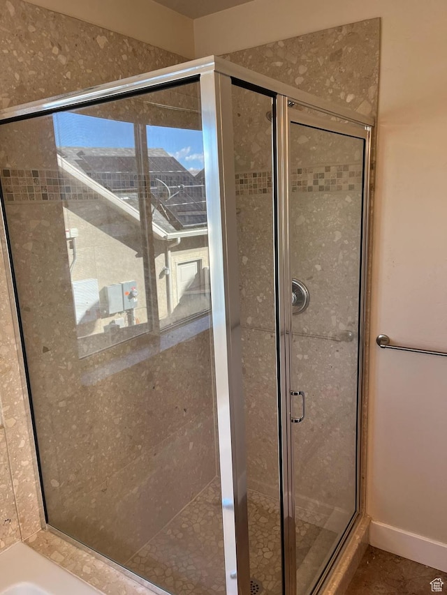 bathroom featuring separate shower and tub