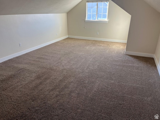 additional living space with carpet and vaulted ceiling
