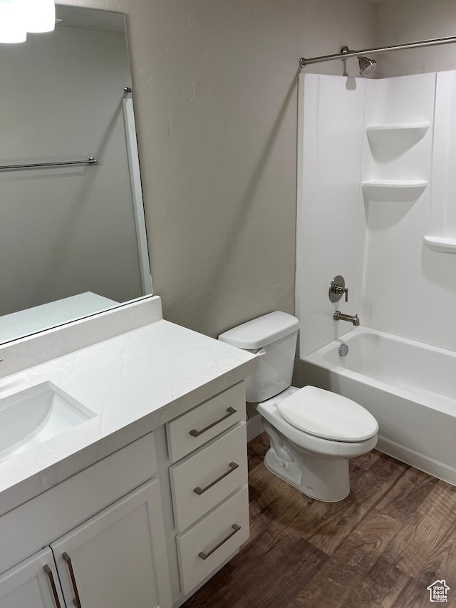 full bathroom with wood-type flooring, vanity, toilet, and shower / washtub combination
