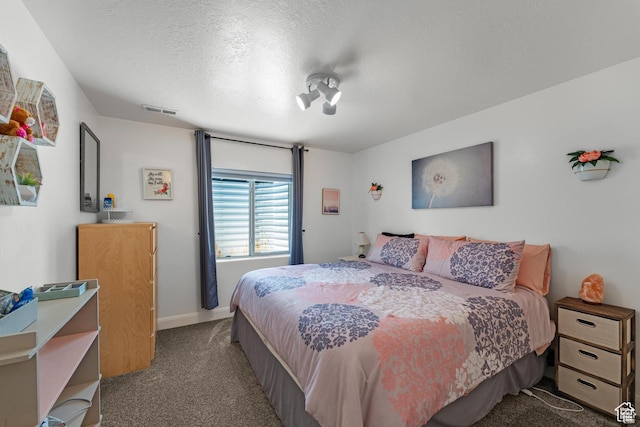 carpeted bedroom with a textured ceiling