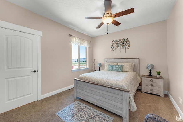 bedroom with ceiling fan and light carpet