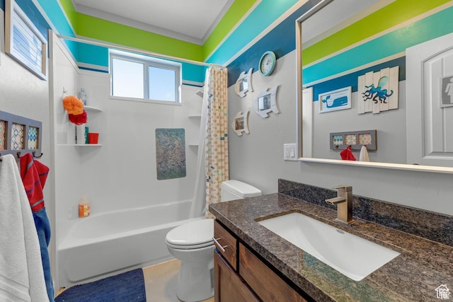 full bathroom with vanity, shower / tub combo, and toilet