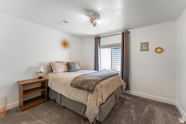 carpeted bedroom with a textured ceiling