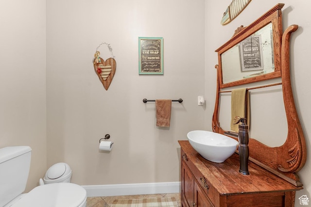 bathroom with tile patterned floors, vanity, and toilet