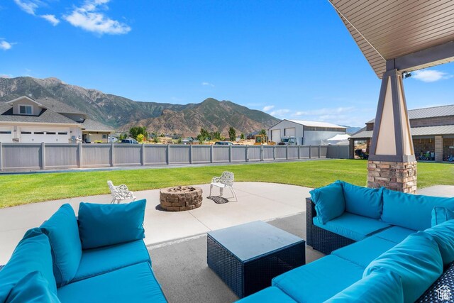 view of patio featuring a mountain view and an outdoor living space with a fire pit
