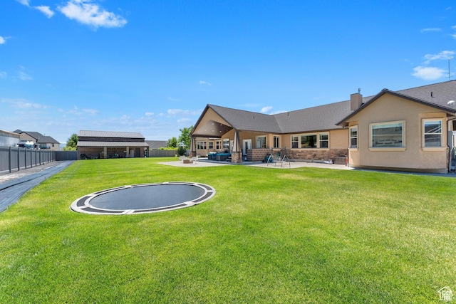 view of yard featuring a trampoline and a patio area