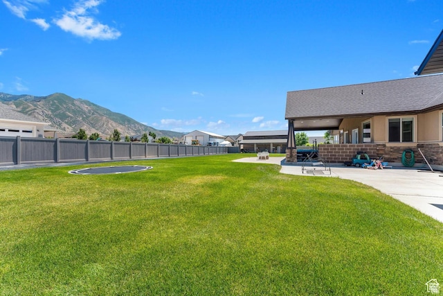view of yard with a mountain view and a patio