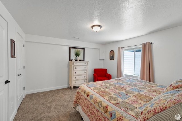 bedroom featuring a textured ceiling and light carpet