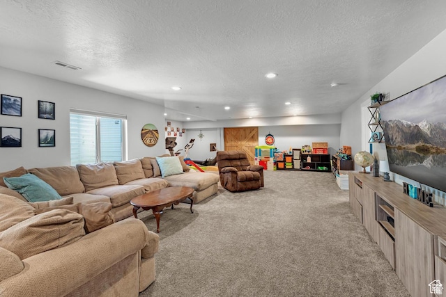 carpeted living room featuring a textured ceiling