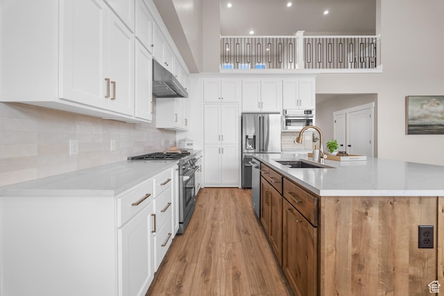 525 N 1550 W Unit Ge01, Mapleton, UT 84664 - kitchen with light stone countertops, stainless steel appliances, under cabinet range hood, and white cabinets