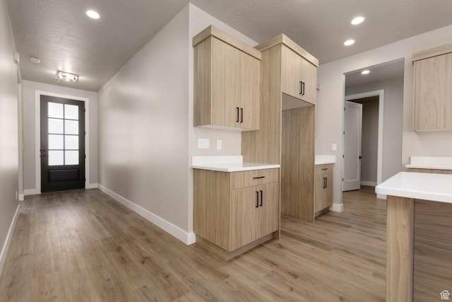 2227 W 320 S, Hurricane, UT 84737 - kitchen with light hardwood / wood-style floors, a textured ceiling, and light brown cabinetry
