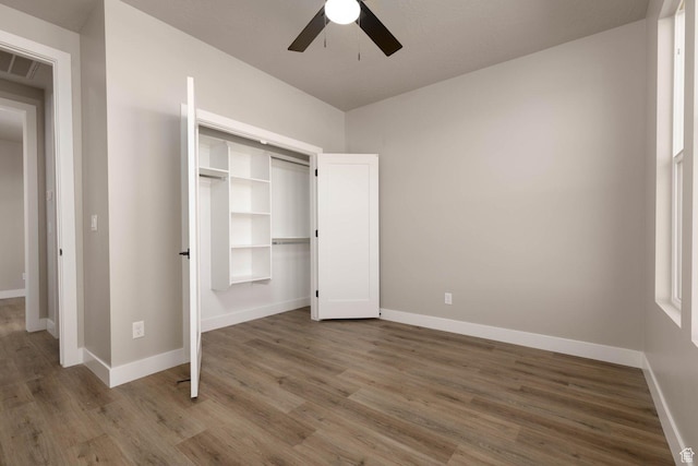 2227 W 320 S, Hurricane, UT 84737 - unfurnished bedroom with ceiling fan, a closet, and hardwood / wood-style floors