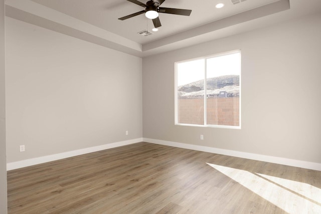 2227 W 320 S, Hurricane, UT 84737 - empty room with ceiling fan, wood-type flooring, and a tray ceiling