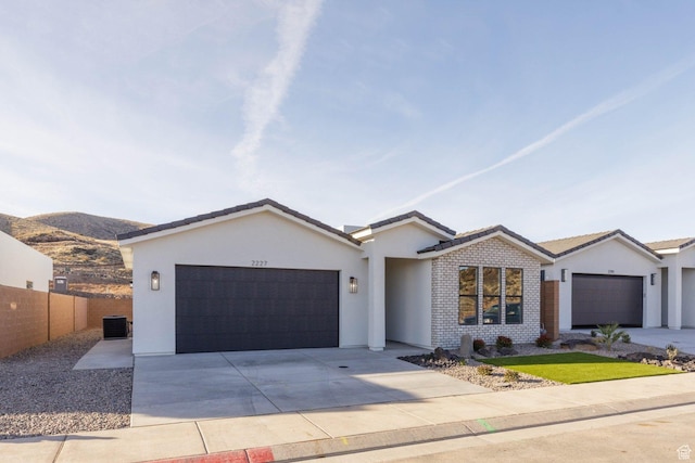2227 W 320 S, Hurricane, UT 84737 - ranch-style home featuring a mountain view, cooling unit, and a garage