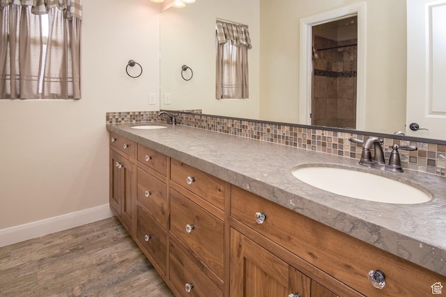 2596 S Little Valley Rd, St George, UT 84790 - bathroom featuring decorative backsplash, wood-type flooring, and vanity