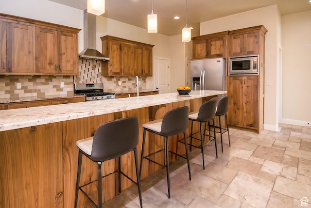 2596 S Little Valley Rd, St George, UT 84790 - kitchen with stainless steel appliances, wall chimney range hood, a kitchen breakfast bar, backsplash, and decorative light fixtures