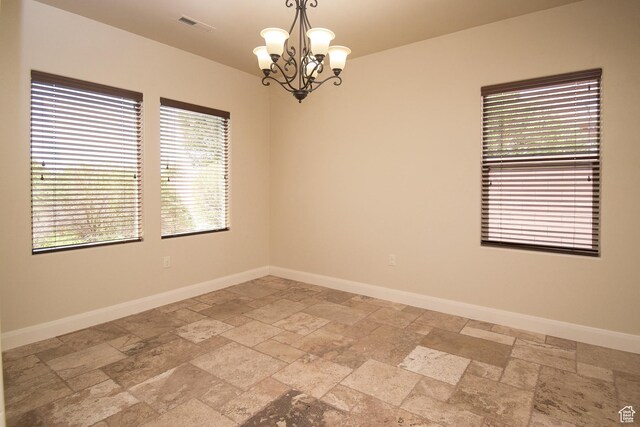 2596 S Little Valley Rd, St George, UT 84790 - unfurnished room featuring a chandelier