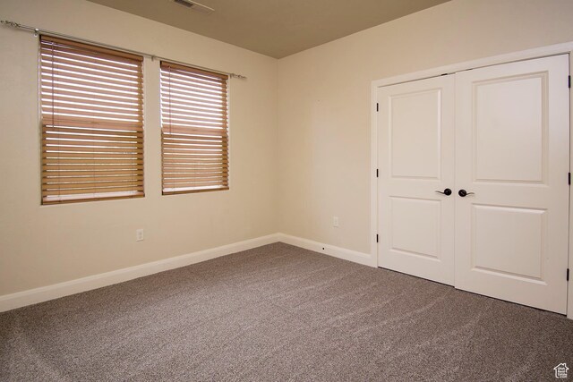 2596 S Little Valley Rd, St George, UT 84790 - unfurnished bedroom featuring carpet and a closet