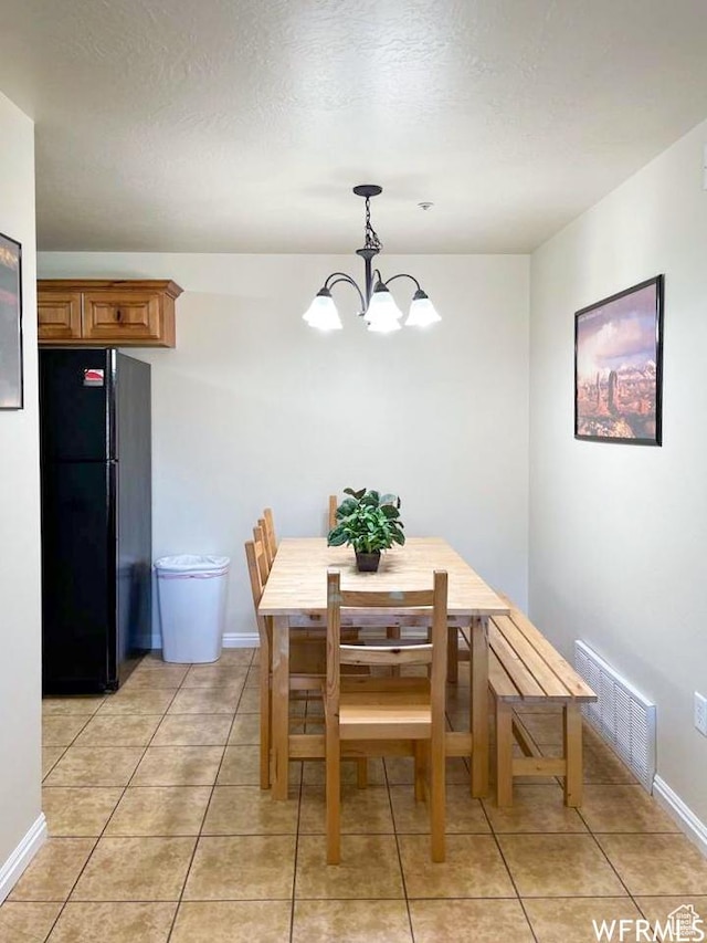 2511 Redcliff Rd Unit 1D, Moab, UT 84532 - tiled dining space featuring a textured ceiling and a notable chandelier