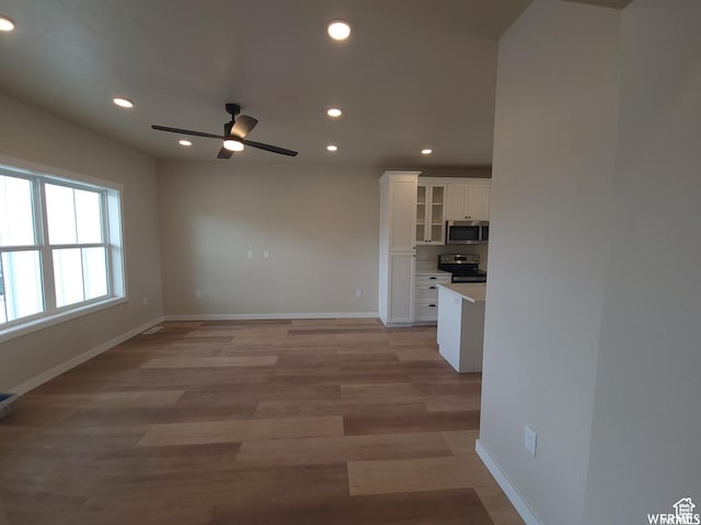 interior space featuring light hardwood / wood-style flooring and ceiling fan