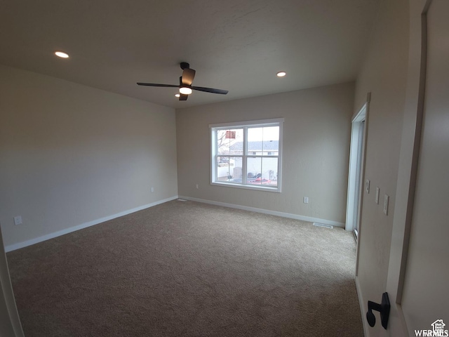 empty room featuring ceiling fan and carpet floors