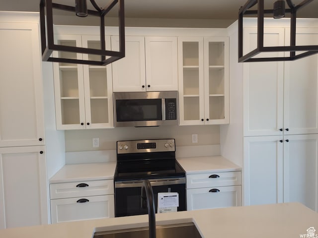 kitchen featuring stainless steel appliances and white cabinetry