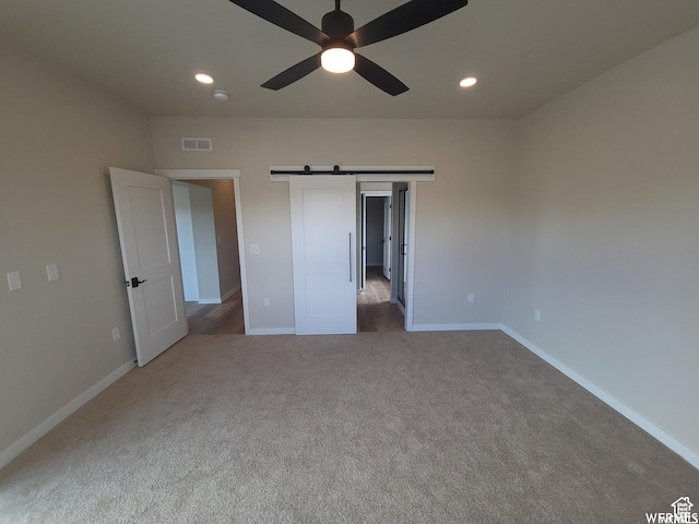 unfurnished bedroom with carpet flooring and ceiling fan