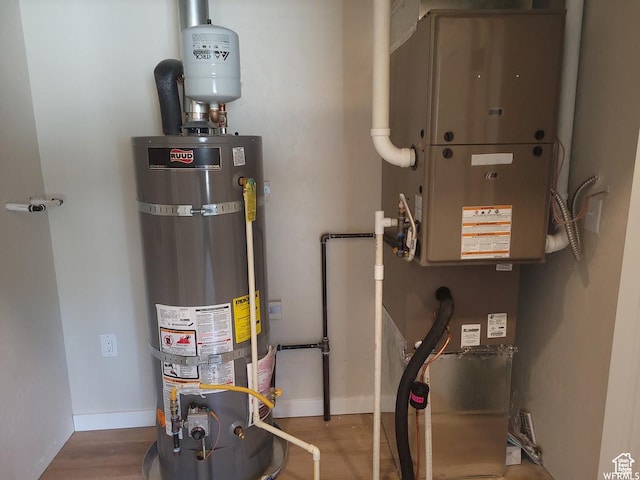utility room with strapped water heater and heating unit