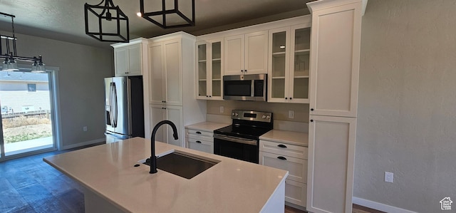831 N 1820 E Unit 66, Price, UT 84501 - kitchen featuring pendant lighting, white cabinets, sink, an island with sink, and appliances with stainless steel finishes