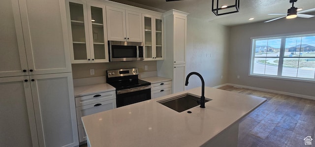 831 N 1820 E Unit 66, Price, UT 84501 - kitchen with white cabinetry, sink, appliances with stainless steel finishes, and an island with sink