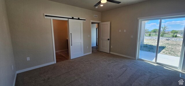 831 N 1820 E Unit 66, Price, UT 84501 - unfurnished bedroom with access to outside, a barn door, ceiling fan, and carpet floors
