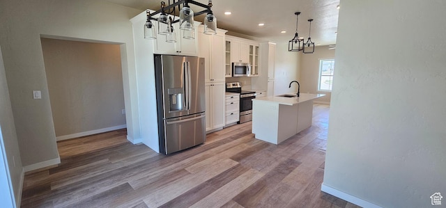 831 N 1820 E Unit 66, Price, UT 84501 - kitchen featuring white cabinetry, sink, hanging light fixtures, a center island with sink, and appliances with stainless steel finishes