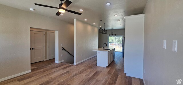 831 N 1820 E Unit 66, Price, UT 84501 - kitchen with ceiling fan, sink, an island with sink, pendant lighting, and light wood-type flooring