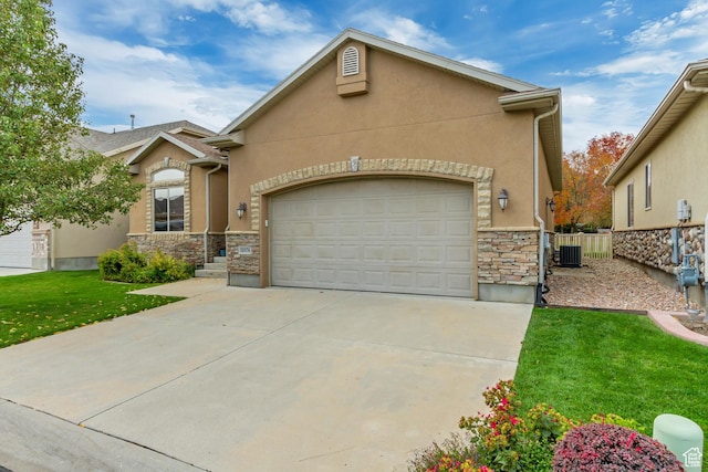 10976 Quartz Dr, South Jordan, UT 84095 - view of front of house with central air condition unit, stucco siding, driveway, stone siding, and fence
