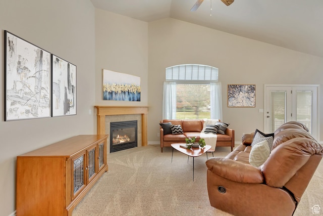 10976 Quartz Dr, South Jordan, UT 84095 - living room featuring high vaulted ceiling, a ceiling fan, light carpet, a tiled fireplace, and baseboards