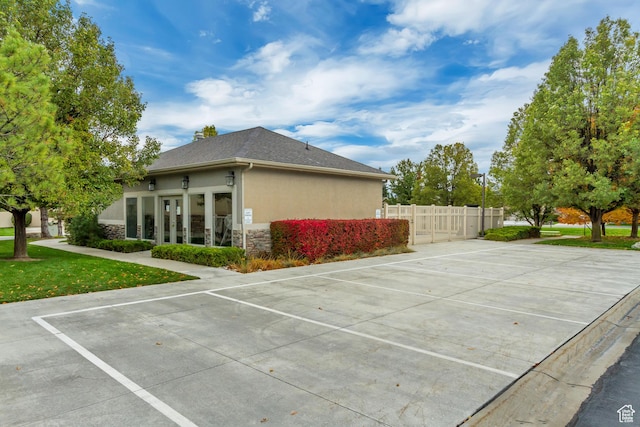 10976 Quartz Dr, South Jordan, UT 84095 - view of home's exterior with stone siding, stucco siding, uncovered parking, and fence