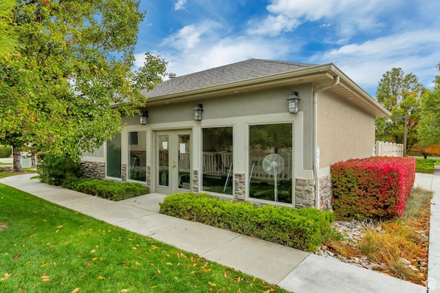 10976 Quartz Dr, South Jordan, UT 84095 - view of home's exterior with french doors, stone siding, a lawn, and stucco siding